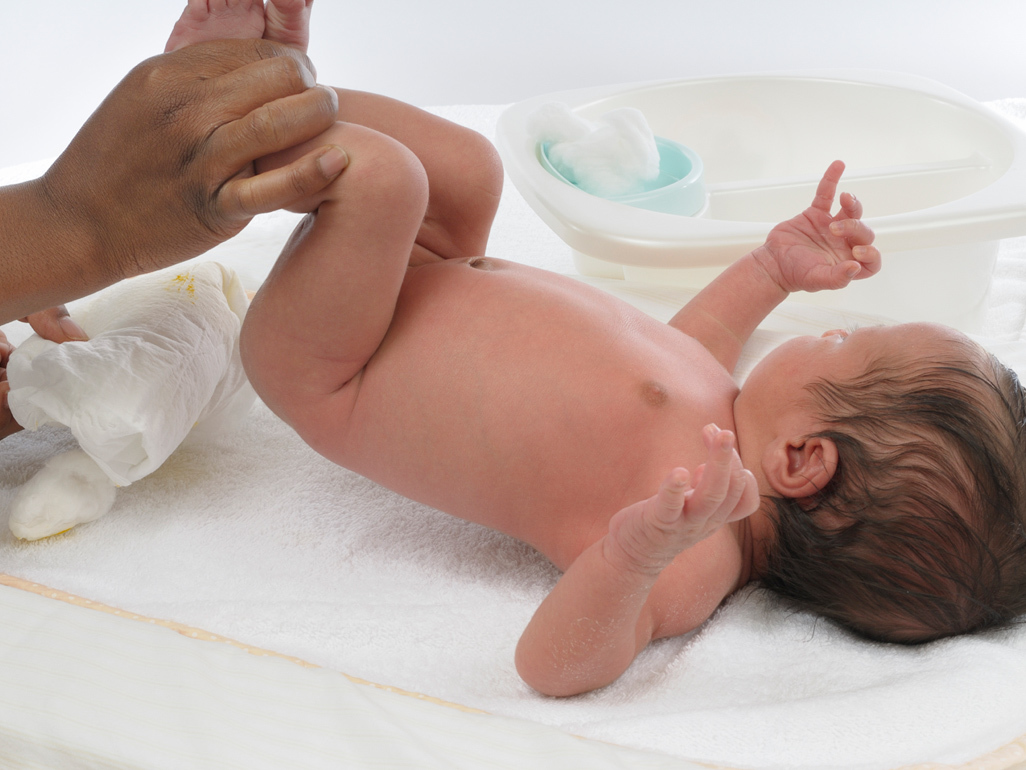 Mum changing newborn's nappy