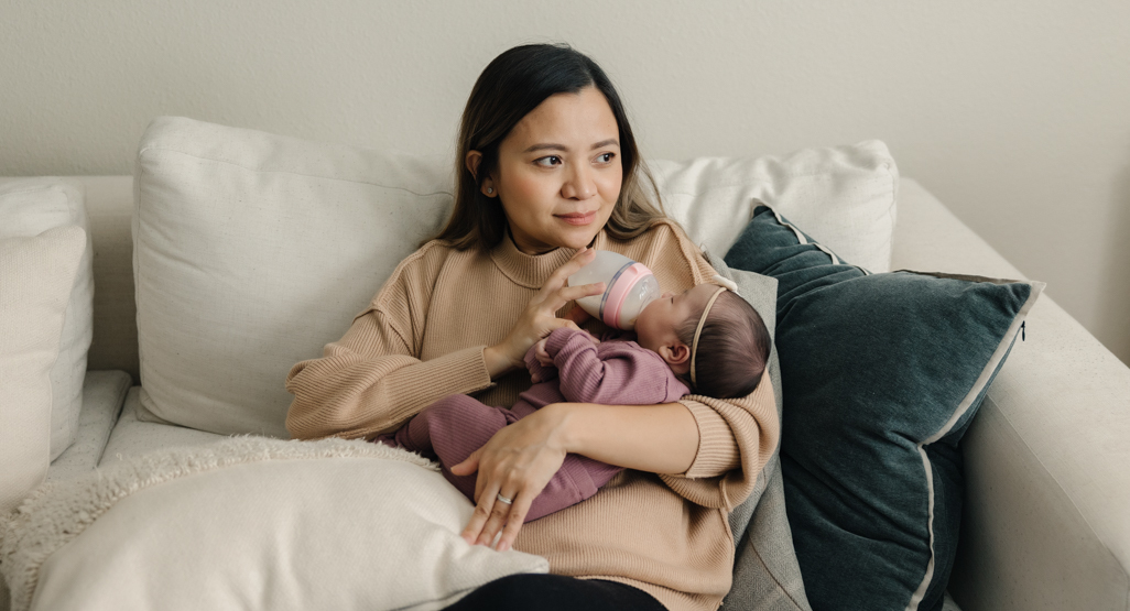 Mum bottle feeding her newborn baby