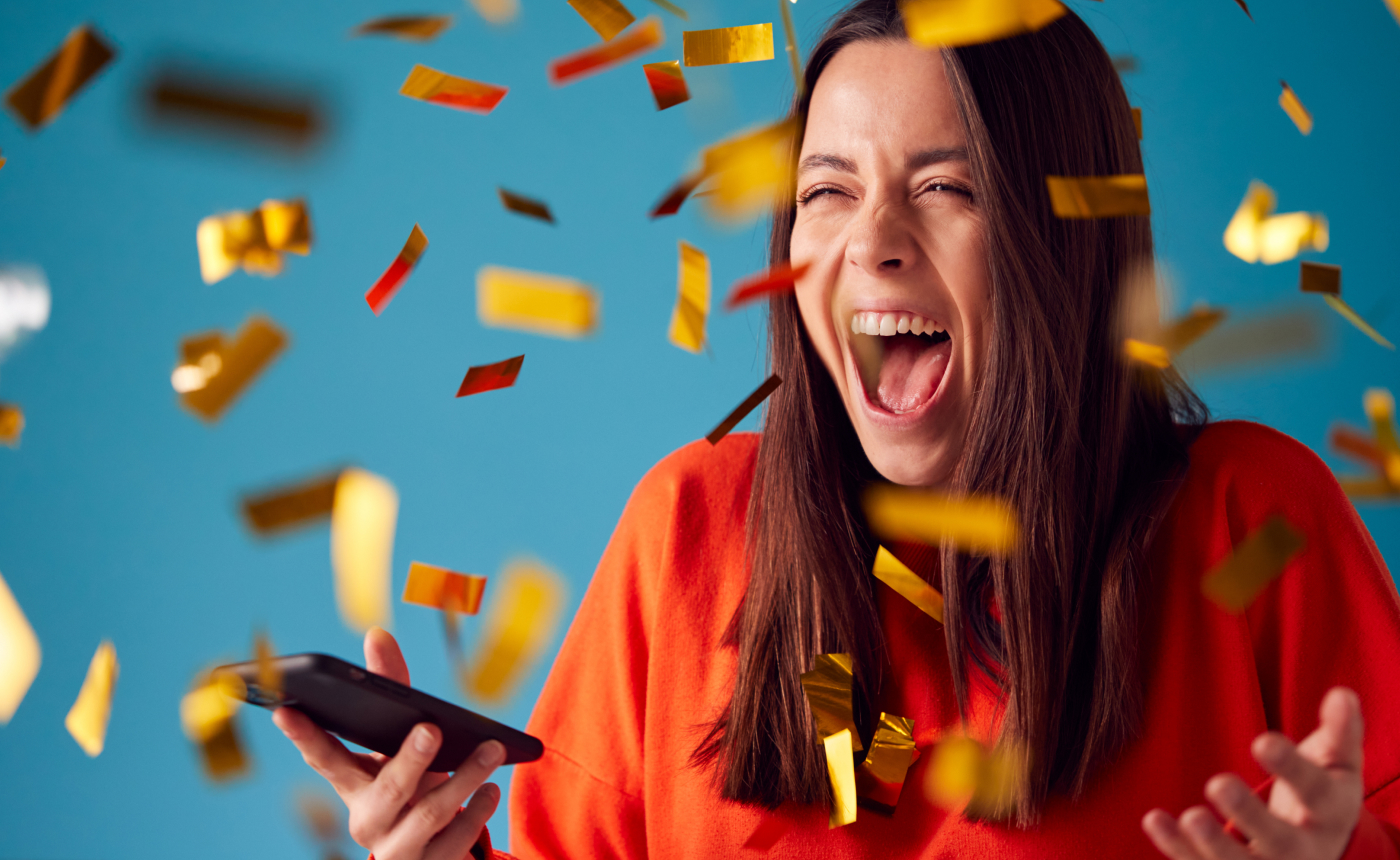 Picture of a woman celebrating, with confetti all around her