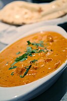 Chicken tikka masala, adapted from Indian chicken tikka and called "a true British national dish." The dish is now popular staple in Indian restaurants worldwide.[34]