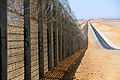 Image 11A more recent section of the Israel-Egypt barrier fence, north of Eilat, June 2012. It is a border barrier built by Israel along its border with Egypt. It was originally an attempt to curb illegal migrants from African countries.[1] Construction was approved on 12 January 2010[2] and began on 22 November 2010.[3]