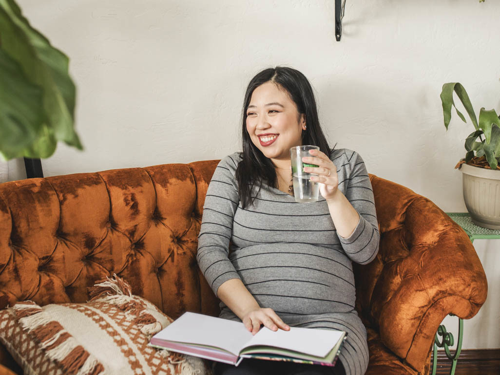 pregnant woman drinking a glass of water