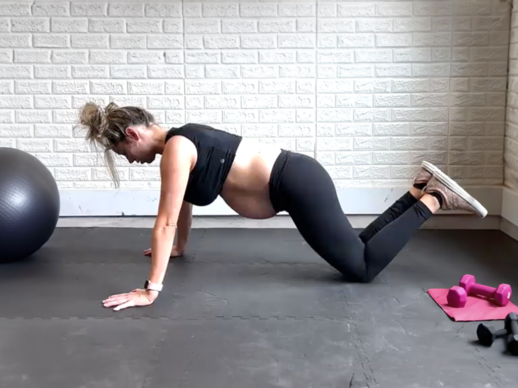 Anna Victoria demonstrating push-up modified to knee push-ups