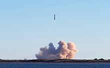 A picture of flying rocket, with large plume at the ground