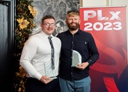 Jack and Chris holding their trophies smiling