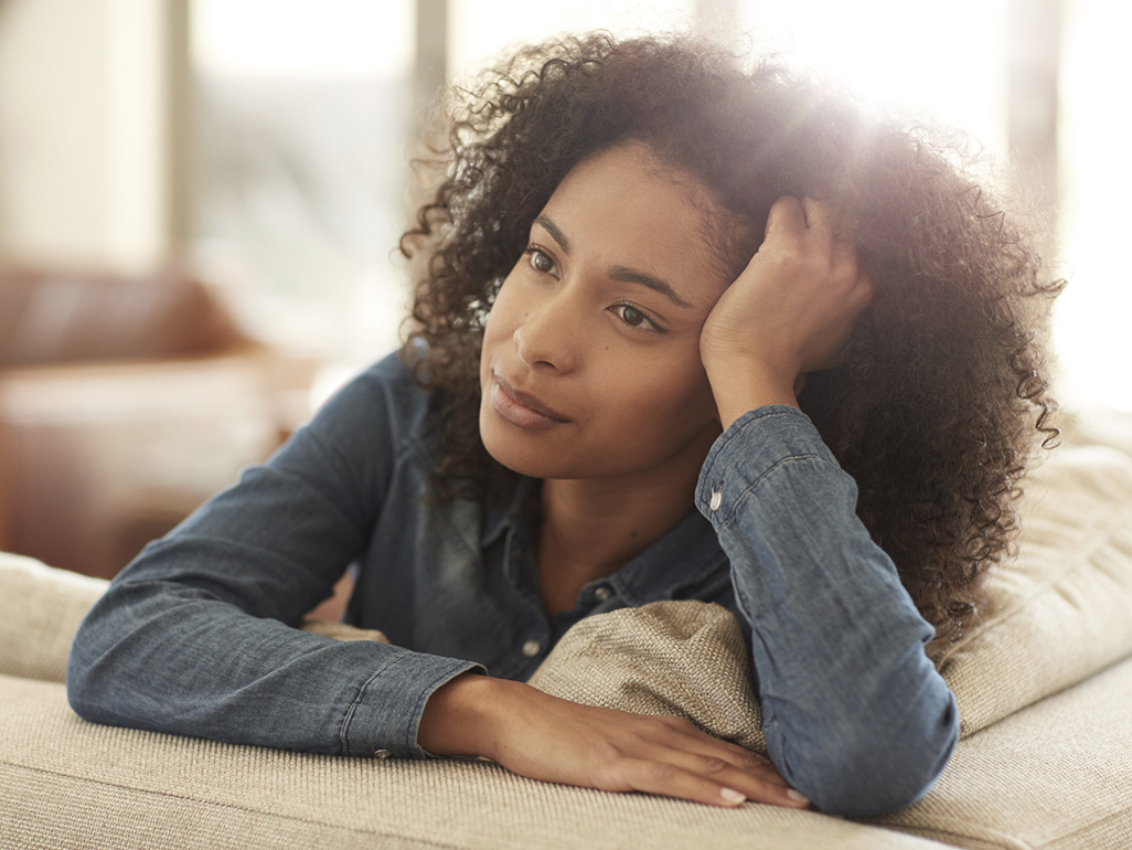 Woman with hand on head thinking