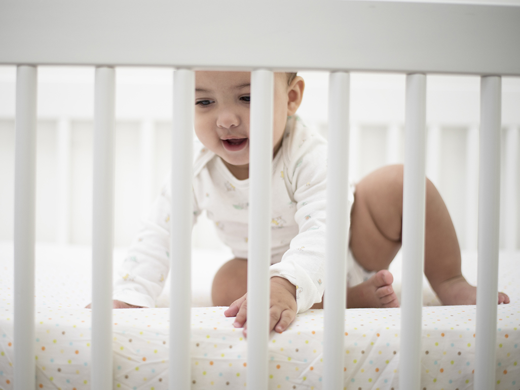 toddler in a crib