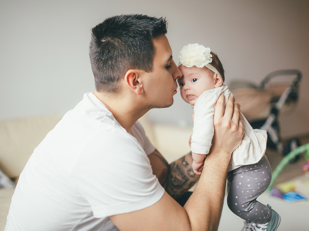 A person holding a baby in their arms