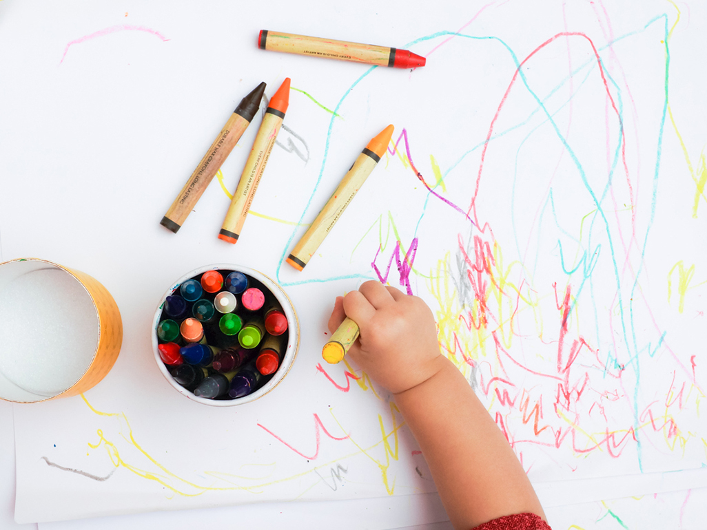 A baby coloring with crayons