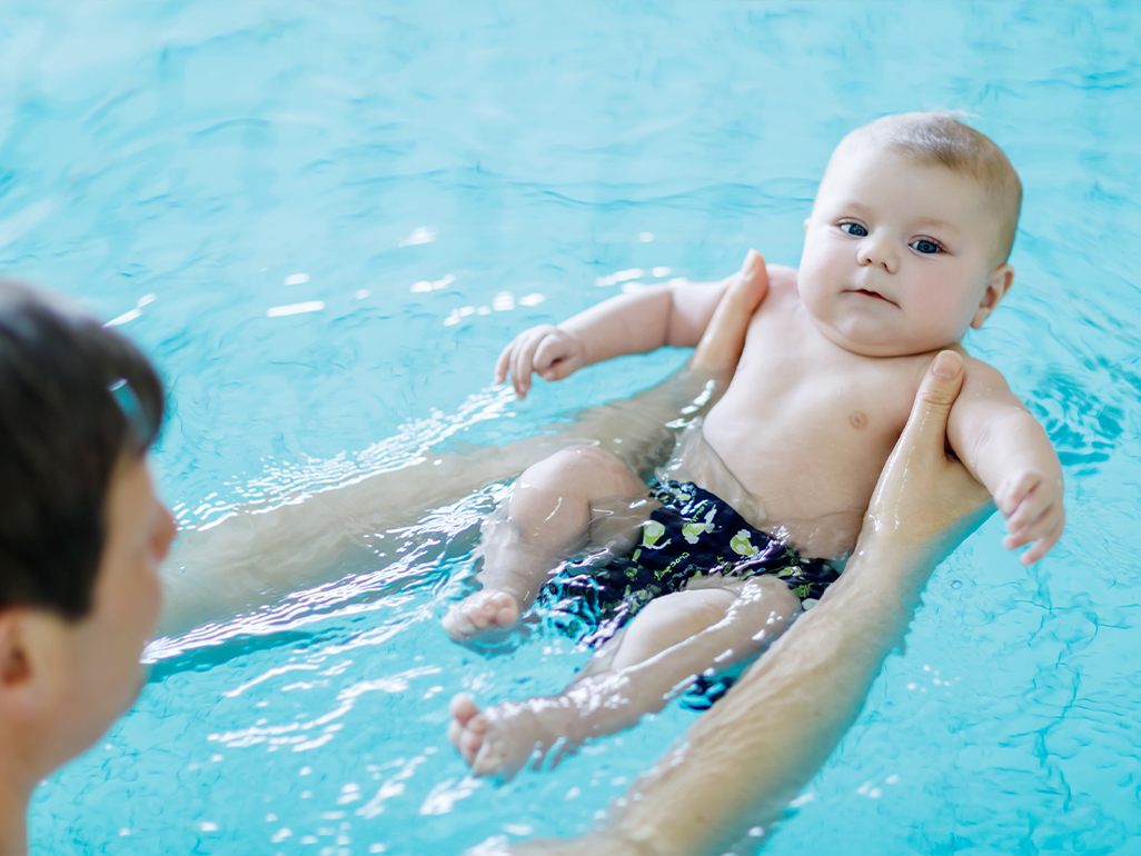 baby in pool with parent