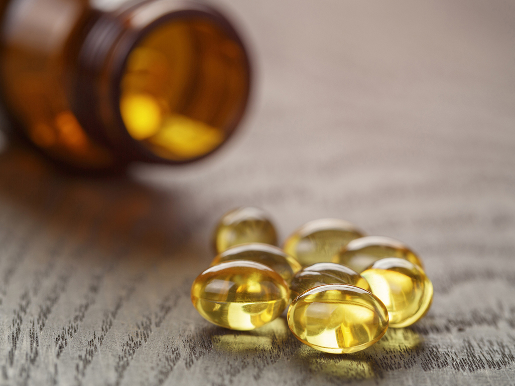 transparent pills on the table in front of a pill bottle