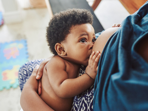 mom breastfeeding older baby