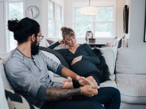 Husband and pregnant wife on sofa