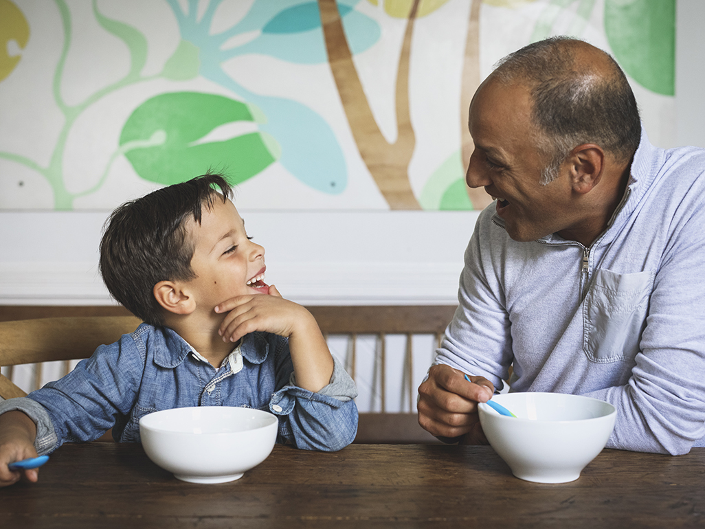 father and son having breakfast