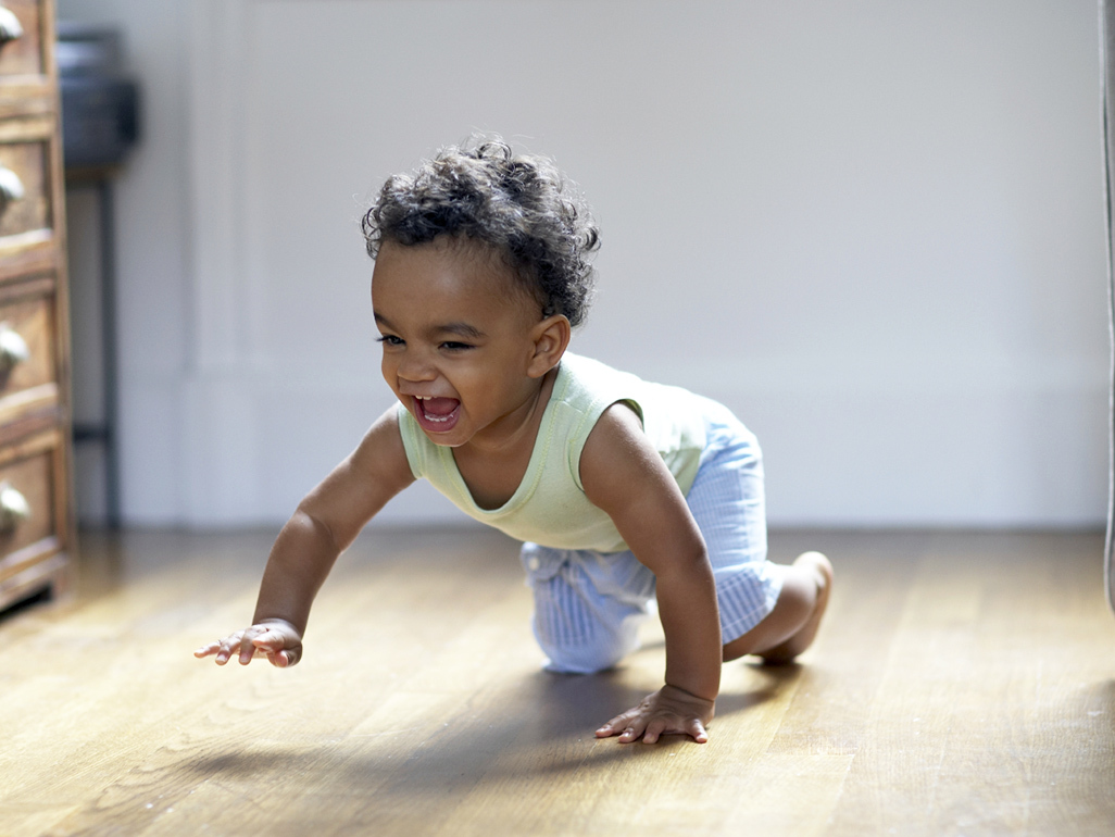 smiling baby boy crawling