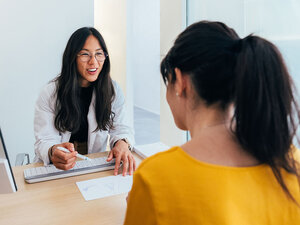 woman talking to doctor about IVF