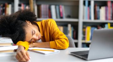 Black female teenage student sleeping at school