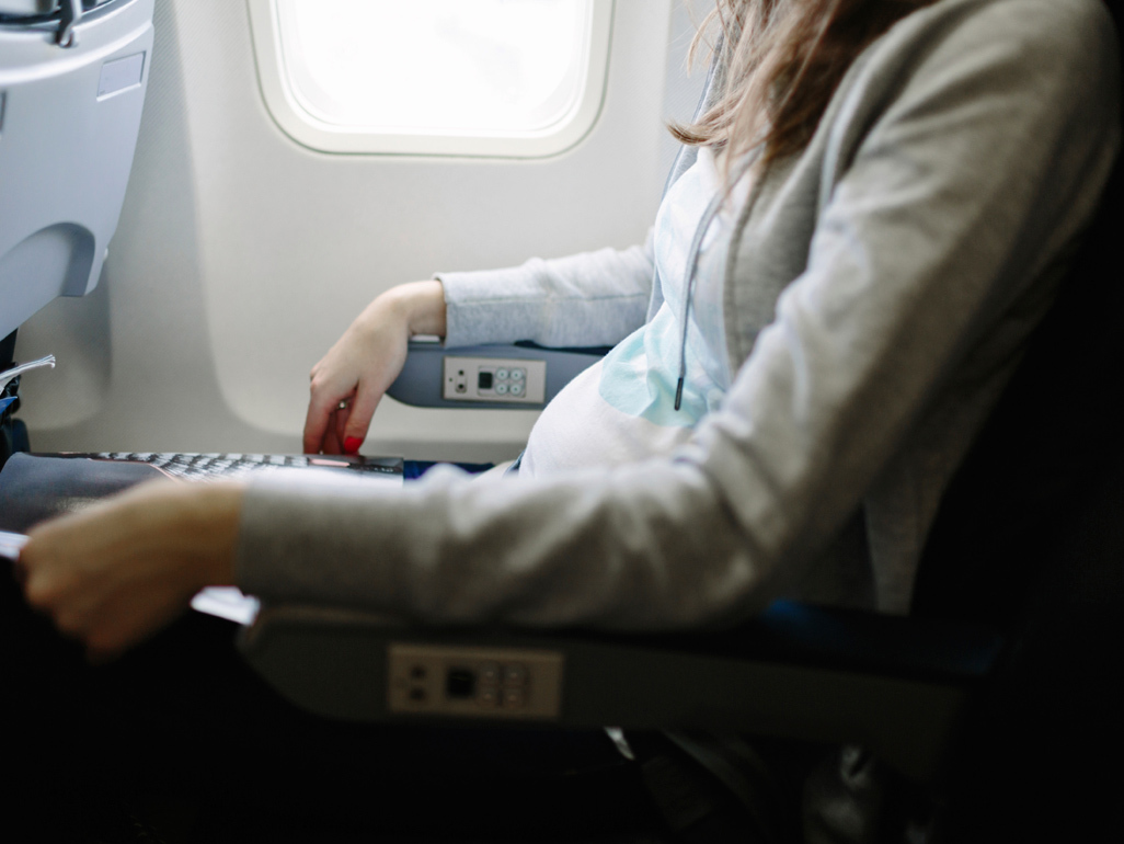 Pregnant woman sitting on a plane