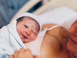 baby with vernix caseosa after birth