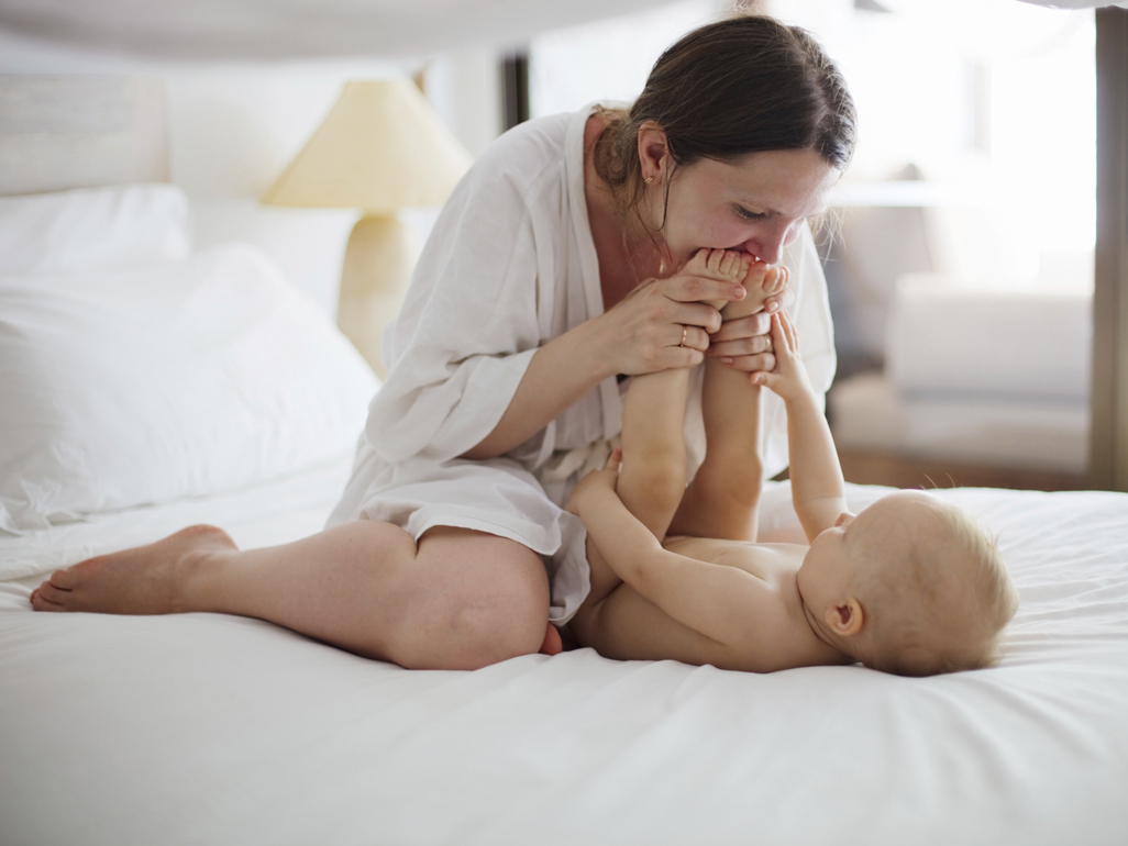 mother kissing a baby's feet