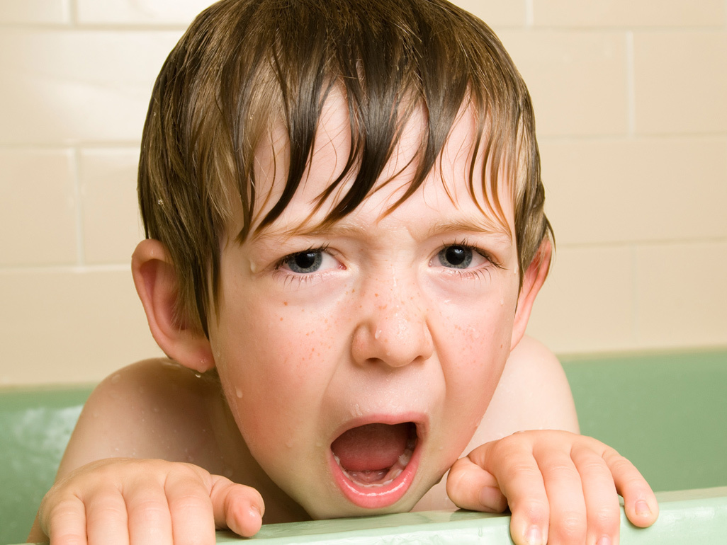 boy looking out a bathtub