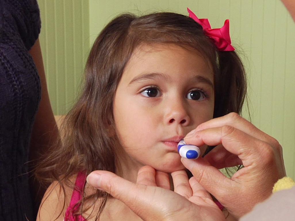 girl with thermometer in mouth