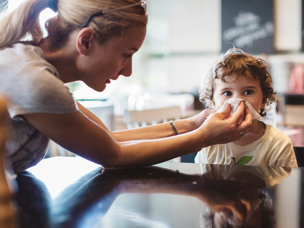 Mom blowing child's nose