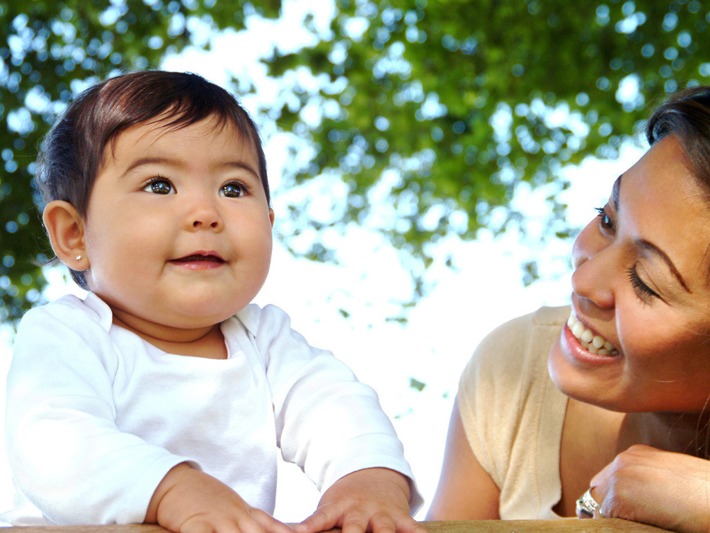 Mother and baby outdoors under tree