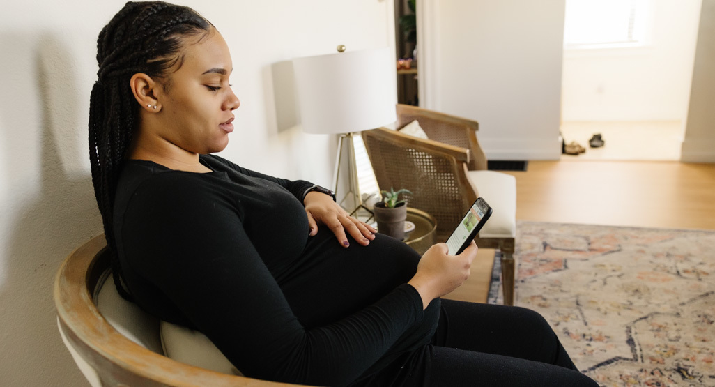 Pregnant woman looking at mobile phone