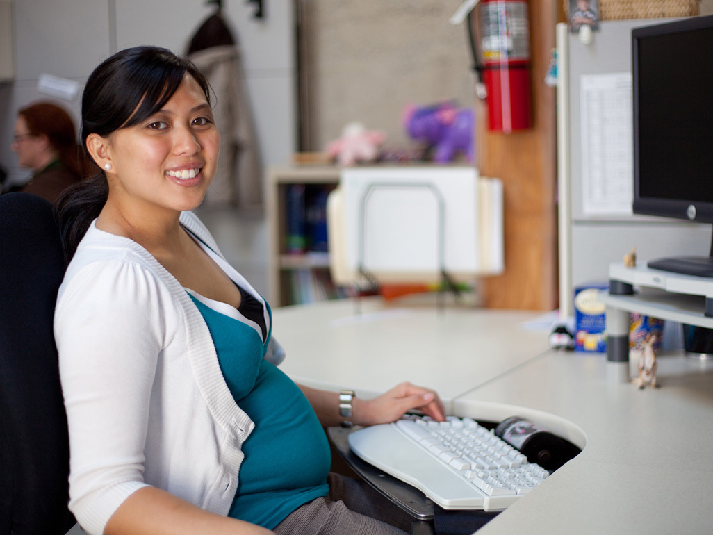 Pregnant woman sitting in an office