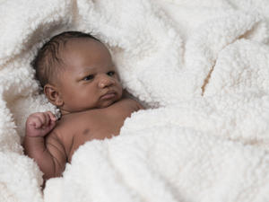 Tiny newborn lying in crib