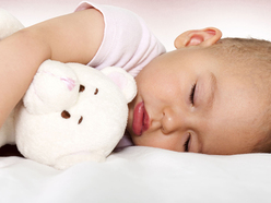 Baby sleeping with cuddly toy