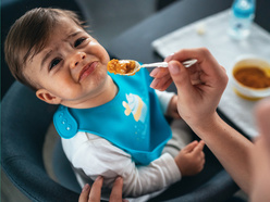 Mother feeding a sick child