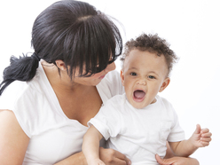 toddler sitting on his mother's lap talking