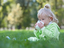 Toddler drinking a glass of cow milk