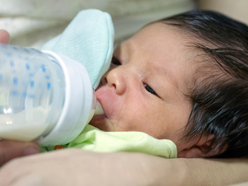 Baby drinking milk from bottle