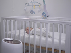 Baby lying in a cot