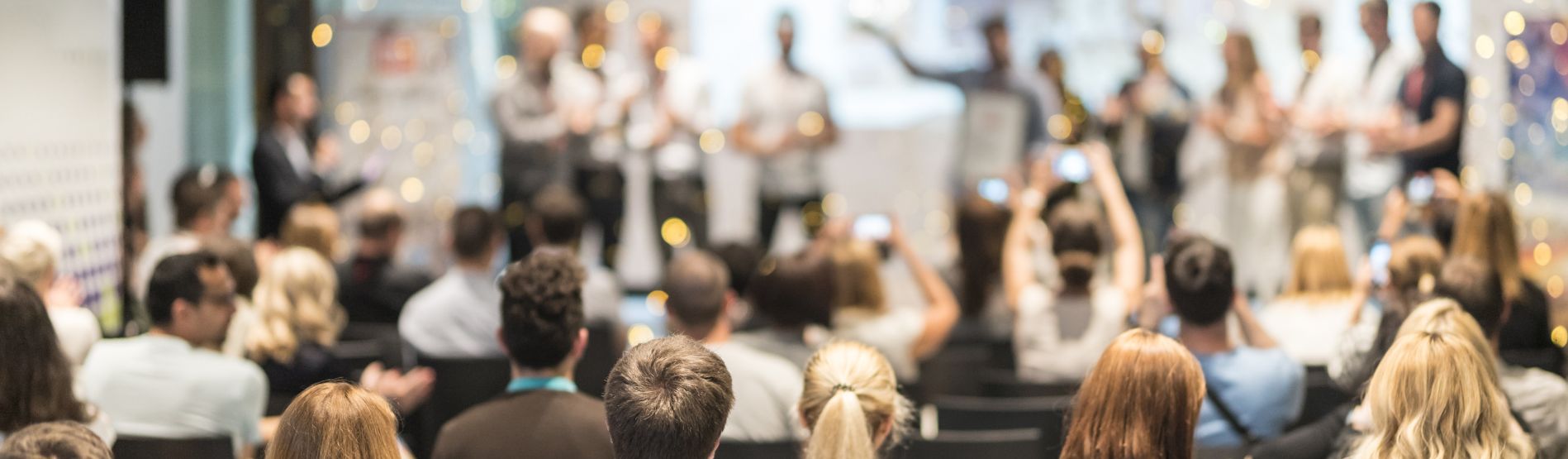 Audience cheering people at an awards ceremony