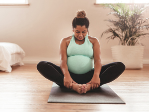 Pregnant woman doing pilates at home