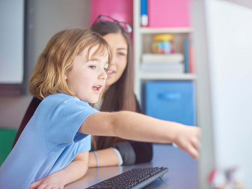 woman and child sitting in front of computer