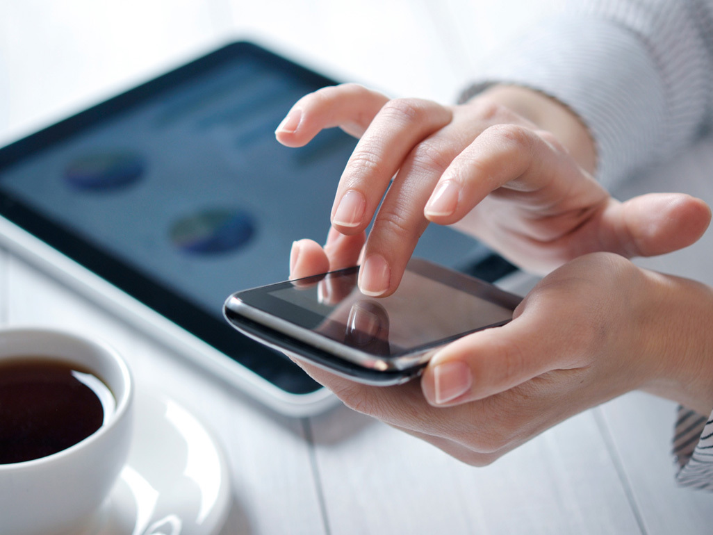 woman touching the screen of her cell phone