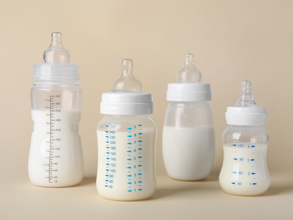 bottles of baby formula on beige background