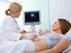 doctor is doing an ultrasound scan on pregnant woman