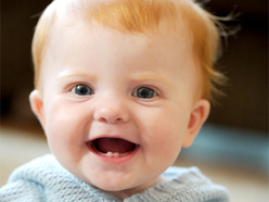 laughing baby with two bottom teeth