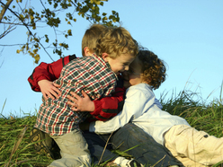 Three children having a play fight