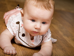 Baby on tummy lifting her neck up