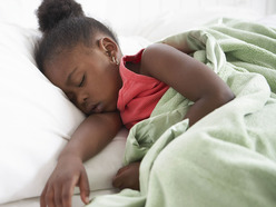 Young girl asleep in bed