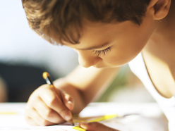 Boy drawing with pencil