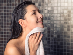 woman in the shower, smiling