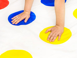 Hands playing Twister